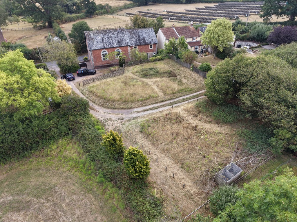 Lot: 170 - FORMER METHODIST CHAPEL WITH PLANNING FOR CONVERSION TO A RESIDENTIAL DWELLING ON PLOT OF 0.39 ACRES - Aerial view of gardens and rear elevation